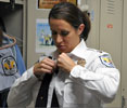 Photo 6 - female officer closes up uniform over her bulletproof vest